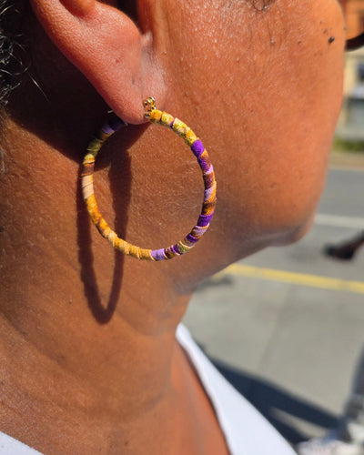 Close-up of a horse's ear with a colorful beaded earring.