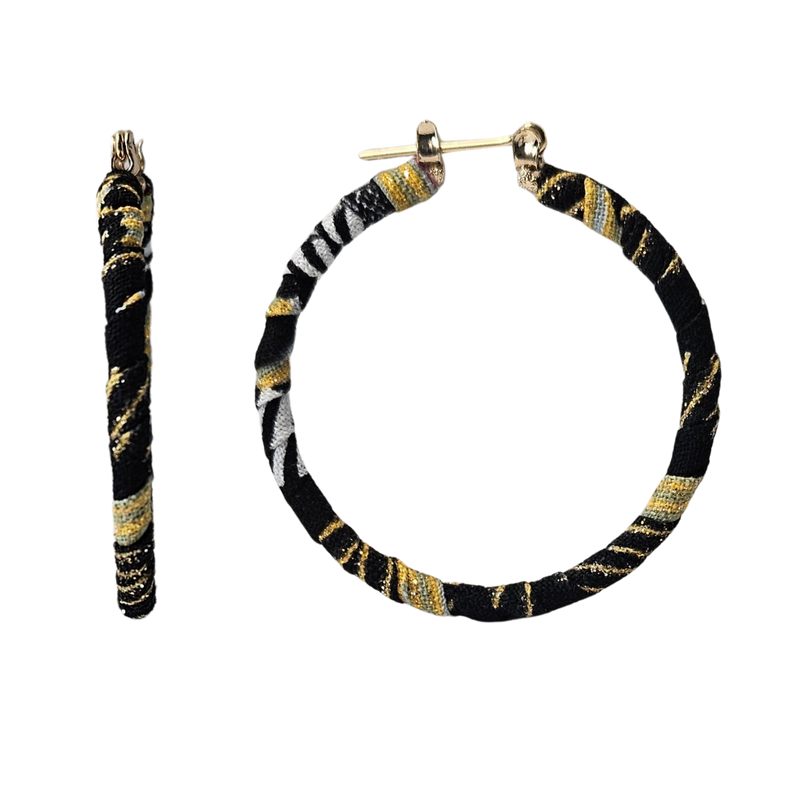 Hoop earrings with black, gold, and white pattern on a white background